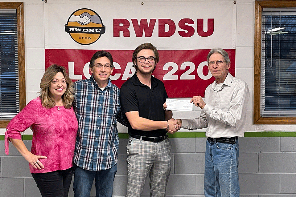 Brandon Drexler (center) with his parents and Michael Leberth, RWDSU Local 220 Union President.