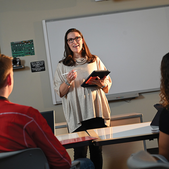 A student teacher speaks to a classroom, impacting the future.