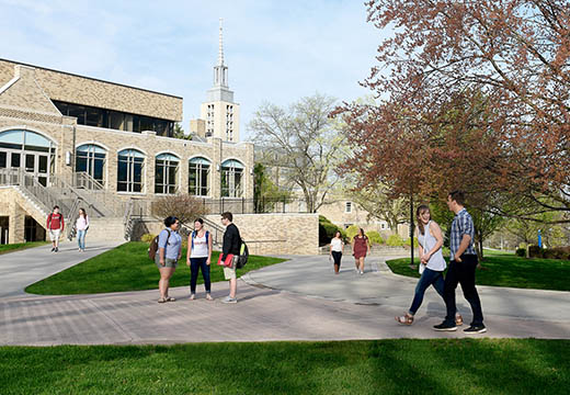 Groups of students walk outside in LeChase Commons